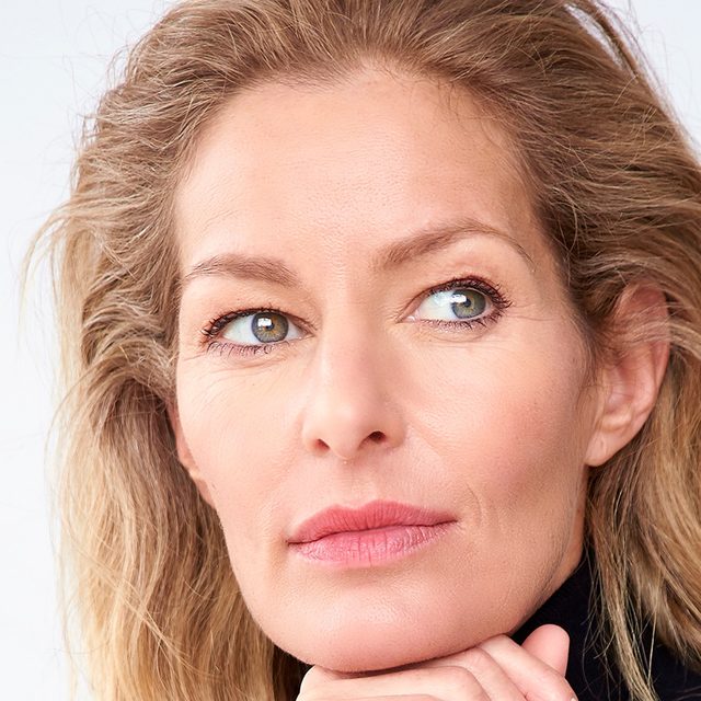 Headshot of woman with blonde hair and light skin staring into the distance.